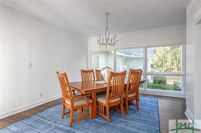 dining space featuring baseboards, wood finished floors, an inviting chandelier, and ornamental molding