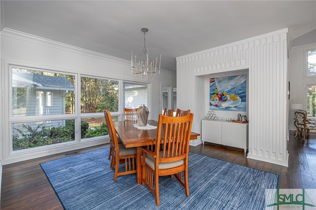 dining space with visible vents, dark wood-style flooring, a chandelier, and ornamental molding