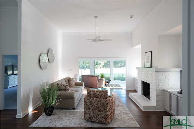 living room featuring dark wood-style floors, a fireplace, baseboards, and ornamental molding