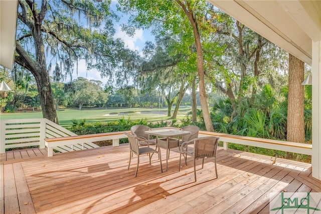 wooden deck featuring outdoor dining area