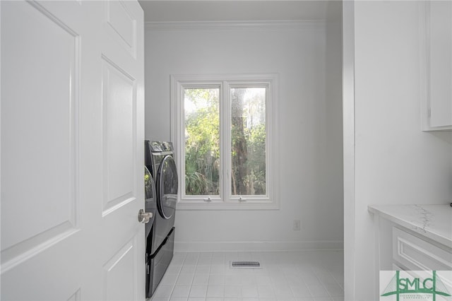 laundry area featuring visible vents, washing machine and dryer, laundry area, and ornamental molding