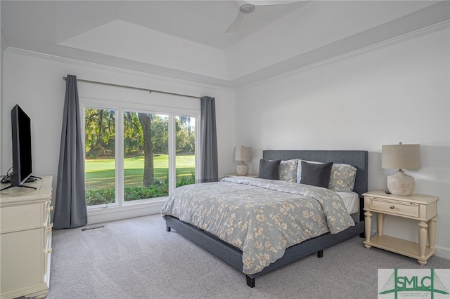 bedroom with a raised ceiling, carpet flooring, visible vents, and ceiling fan