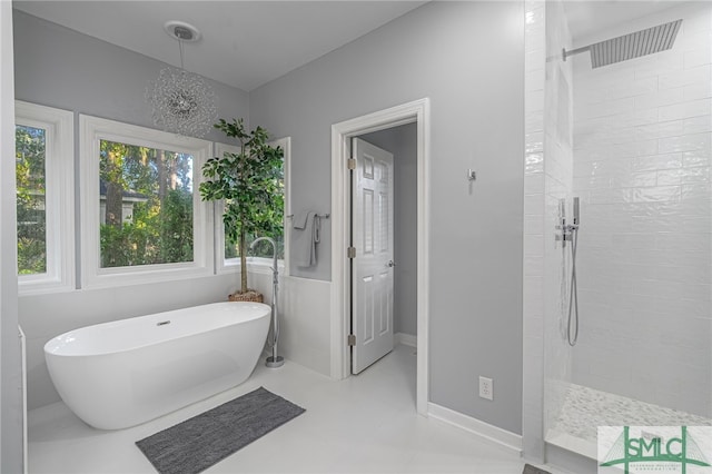 full bath with a freestanding tub, baseboards, and walk in shower