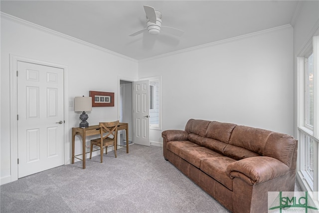 carpeted living room featuring baseboards, a ceiling fan, and crown molding