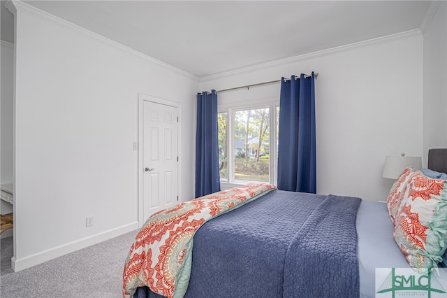 bedroom with crown molding, baseboards, and carpet floors