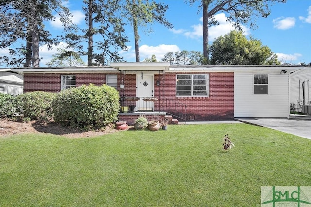 view of front of home featuring concrete driveway, brick siding, and a front lawn