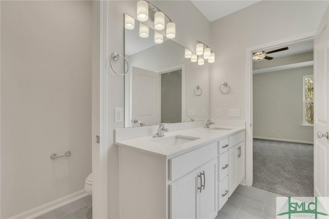 full bathroom with tile patterned floors, a sink, toilet, and double vanity