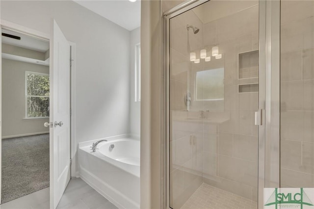 bathroom with a garden tub and a shower stall