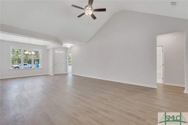 unfurnished living room with high vaulted ceiling, baseboards, wood finished floors, and ceiling fan with notable chandelier