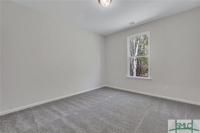 carpeted empty room with visible vents and baseboards