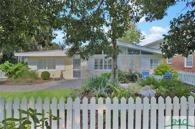 view of front of home featuring fence