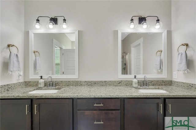 bathroom featuring double vanity and a sink