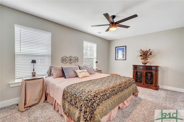 bedroom featuring baseboards, a ceiling fan, visible vents, and light colored carpet