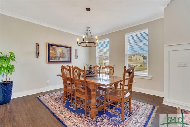 dining area with ornamental molding, dark wood-style flooring, a chandelier, and baseboards