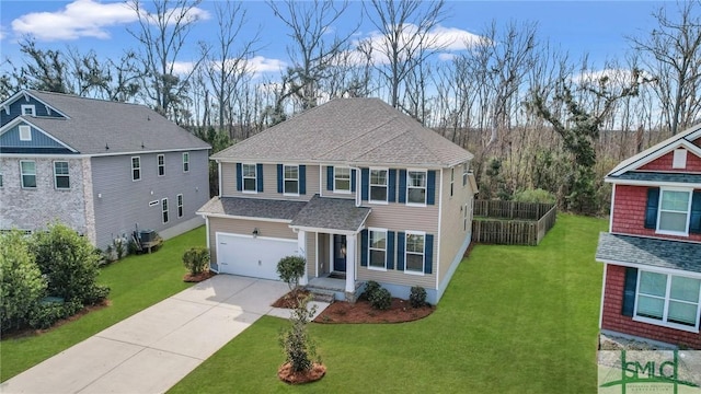 traditional home featuring a shingled roof, fence, a garage, driveway, and a front lawn