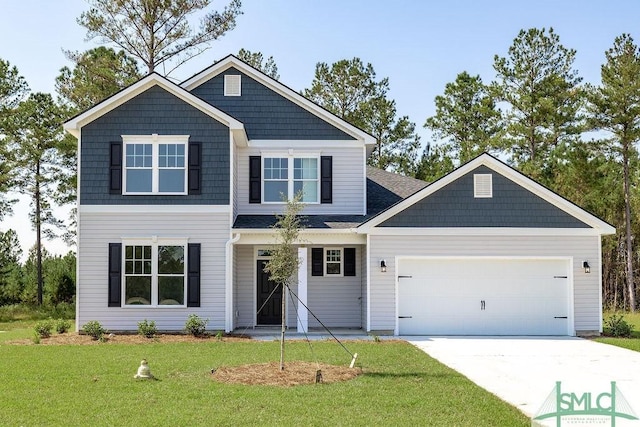 view of front of property featuring an attached garage, driveway, and a front lawn