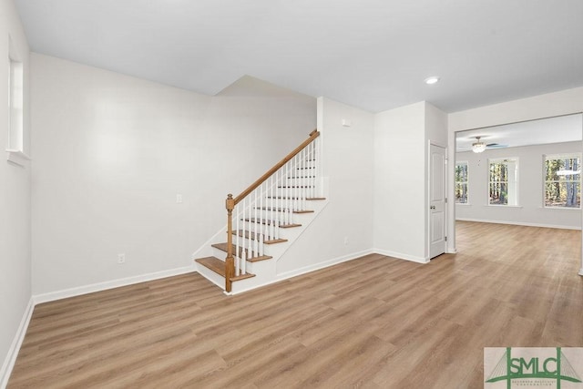 interior space featuring recessed lighting, stairway, light wood-style flooring, ceiling fan, and baseboards