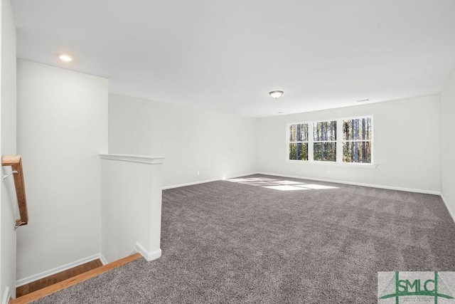 spare room featuring carpet floors, baseboards, and recessed lighting