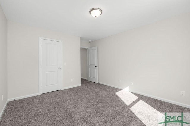 unfurnished bedroom with carpet floors and baseboards