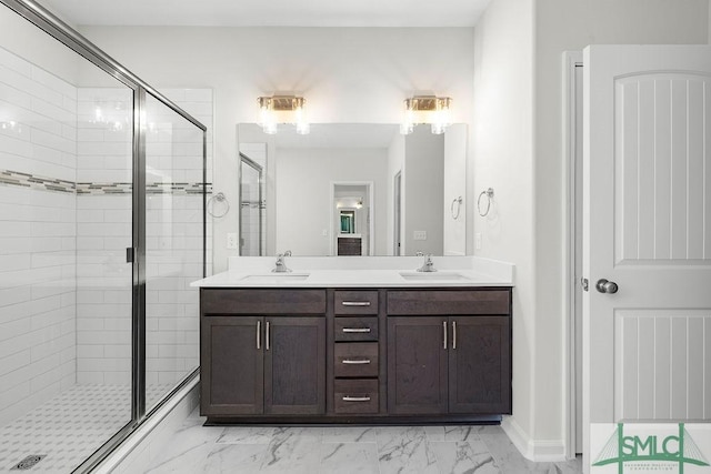 full bath with marble finish floor, a sink, and a shower stall