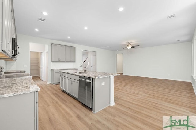 kitchen featuring visible vents, appliances with stainless steel finishes, gray cabinets, and a sink