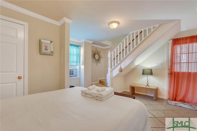 tiled bedroom featuring multiple windows, crown molding, and baseboards