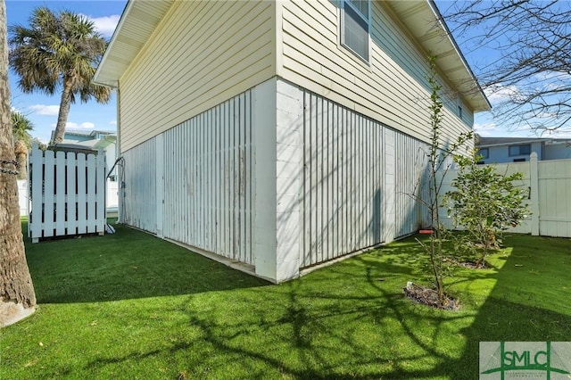 view of side of property with a yard and fence