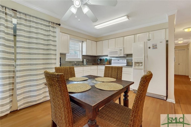 dining space with ornamental molding, a ceiling fan, and light wood-style floors