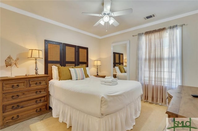 bedroom featuring ornamental molding, light tile patterned flooring, visible vents, and a ceiling fan