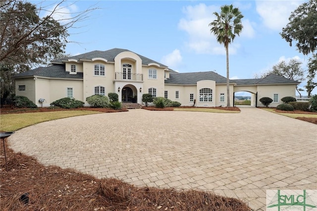 9 Judsons Ct, Savannah, GA 31410 - french country home with curved driveway, stucco siding, and french doors
