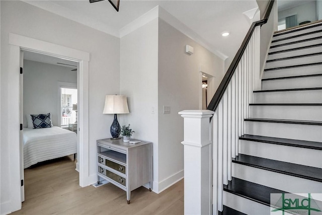 staircase featuring recessed lighting, wood finished floors, and baseboards