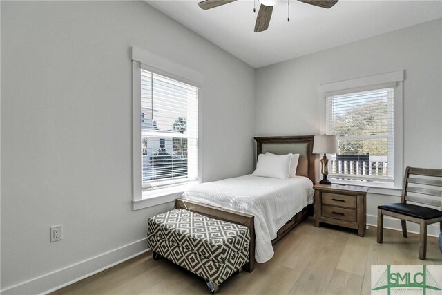 bedroom featuring a ceiling fan, baseboards, and wood finished floors