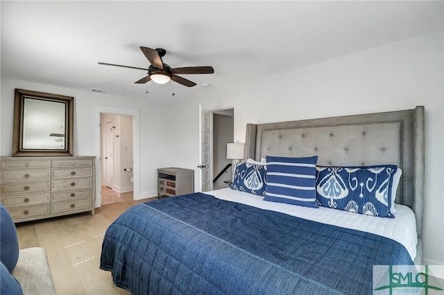 bedroom with a ceiling fan, visible vents, and wood finished floors