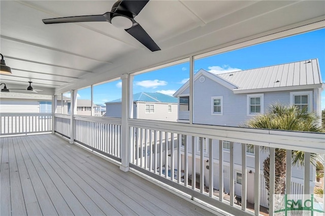 wooden deck with a residential view and ceiling fan