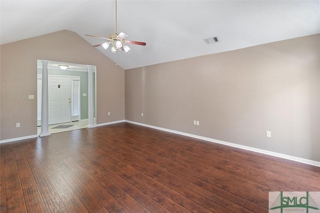 spare room with visible vents, baseboards, lofted ceiling, dark wood-style floors, and ceiling fan