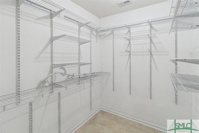 walk in closet with visible vents