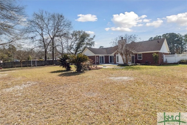 exterior space with a yard, a chimney, a patio, and fence