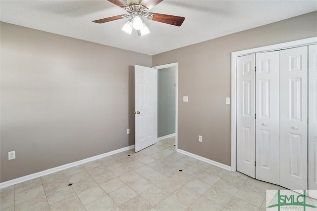 unfurnished bedroom with a ceiling fan, a closet, and baseboards