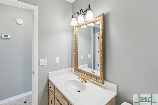 bathroom with vanity and baseboards