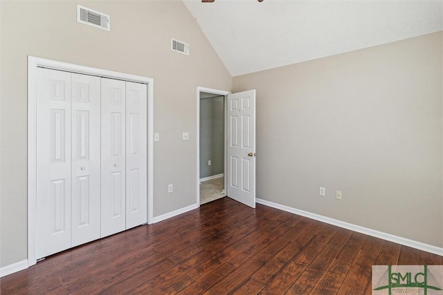 unfurnished bedroom featuring a closet, wood finished floors, visible vents, and baseboards