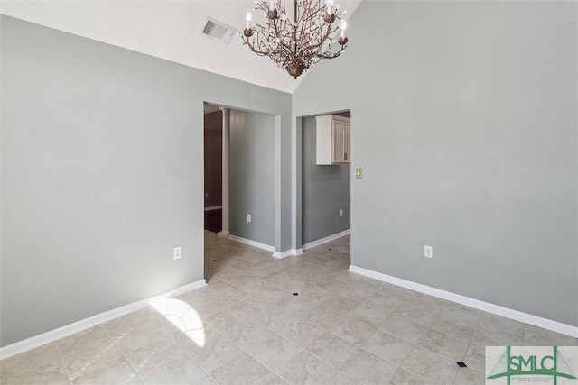 spare room featuring high vaulted ceiling, visible vents, a notable chandelier, and baseboards