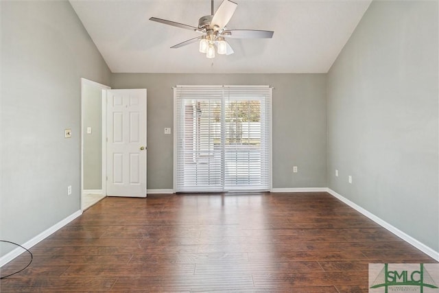 spare room with a ceiling fan, baseboards, vaulted ceiling, and wood finished floors