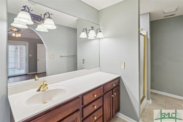 bathroom featuring vanity, baseboards, a ceiling fan, tile patterned floors, and a stall shower