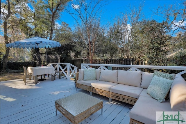 wooden deck featuring outdoor dining space, fence, and an outdoor living space