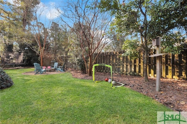 view of yard with an outdoor fire pit and a fenced backyard