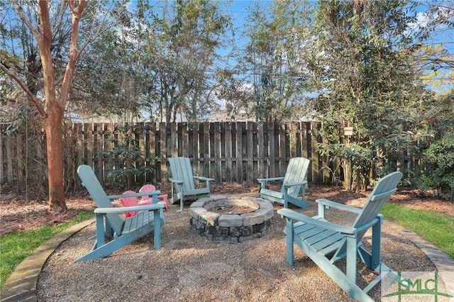 view of yard featuring a patio area, an outdoor fire pit, and fence