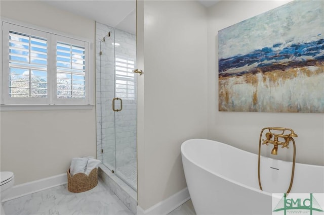 full bath featuring marble finish floor, a shower stall, baseboards, and a soaking tub