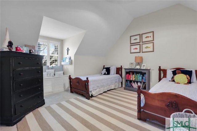 bedroom with carpet floors and lofted ceiling