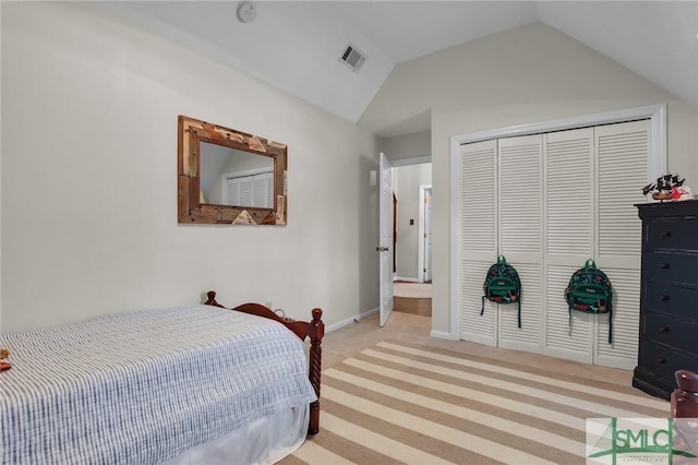 bedroom featuring baseboards, visible vents, lofted ceiling, carpet flooring, and a closet