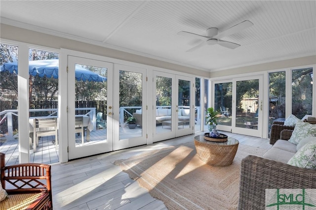 sunroom / solarium featuring french doors and ceiling fan